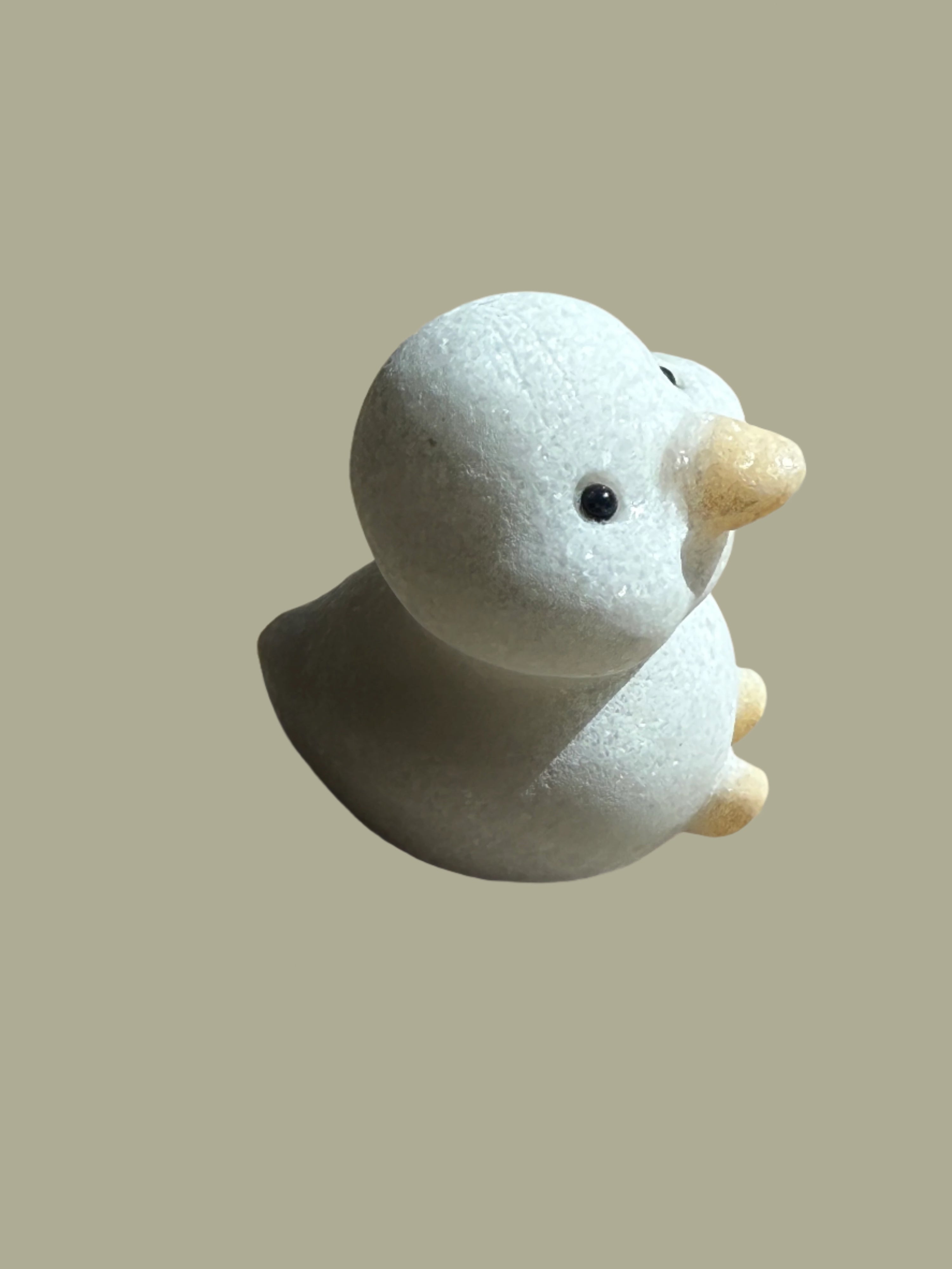 Small white unicorn figurine on a textured surface