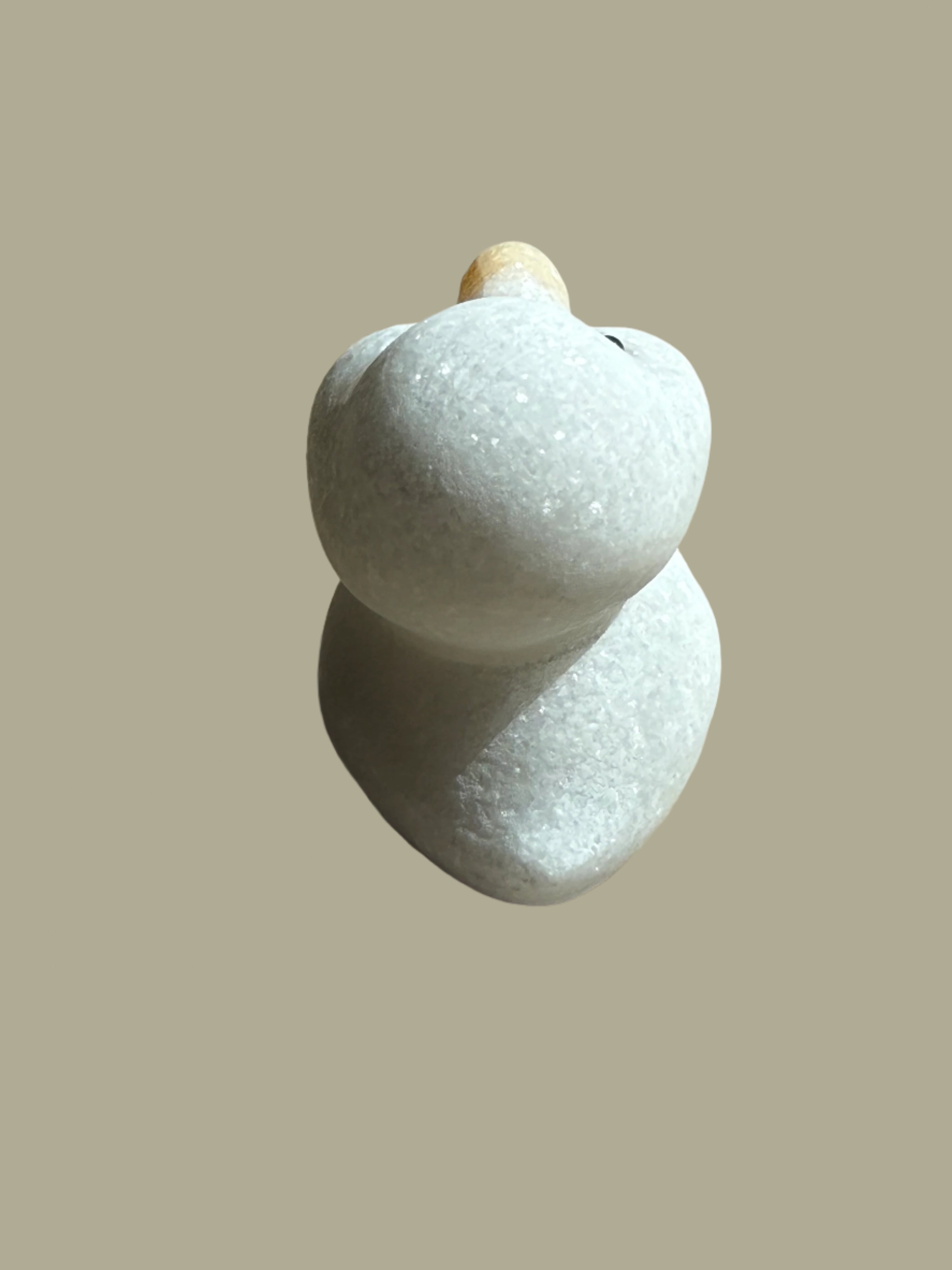 Two white stones on a textured surface