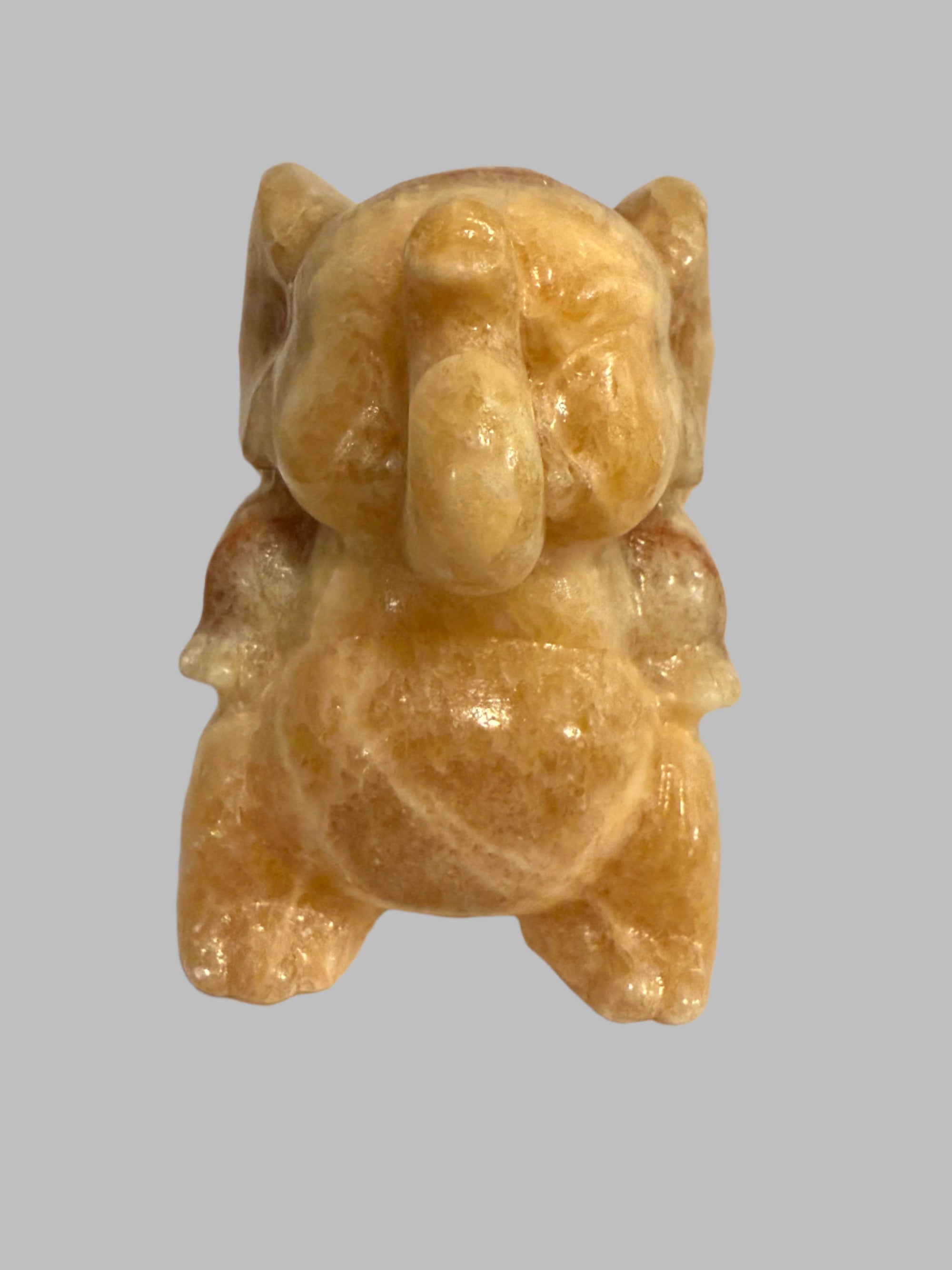 Carved stone figure of a bear on a white background